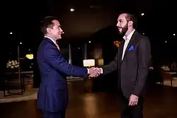 Noboa and Nayib Bukele are shaking hands and facing each other.