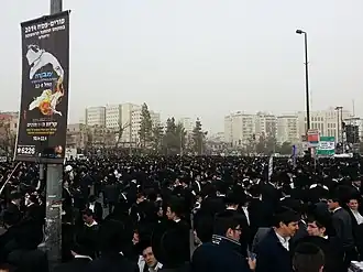 Large crowd of young men, dressed in black