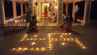 A swastika design made using Diyas inside a Hindu temple