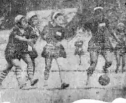 Grainy black and white photograph showing Korean teen girls playing football