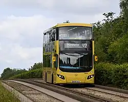 A route V2 bus heading to Manchester Royal Infirmary approaching the Newearth Road stop on the guided busway section in June 2025.