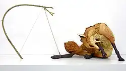 Title: "Trapped" Year: 2015 Dimensions: Figure: H 21 x L 37 x D 22 in. Materials: Stoneware, paint, 18 k gold, rope, wood