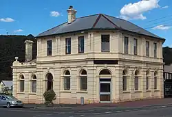 Former bank at 112 Main Street Zeehan. It was constructed by the Commercial Bank of Tasmania and opened in 1899.[37] It was merged into the English, Scottish and Australian Bank in 1921 and the ANZ Bank in 1970, but the branch was closed by ANZ in late 2016.