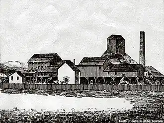 The workshops at the Saint-Joseph shaft; behind, the headframe and chimney c. 1884.