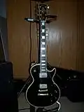 A Gibson Les Paul Custom guitar with an ebony fretboard