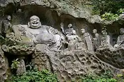 Budai as Maitreya at the Feilai Feng grottoes, depicted with disciples