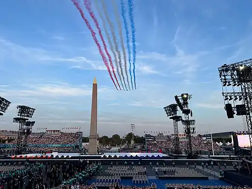 The Patrouille de France flies over the Place de la Concorde to start the parade