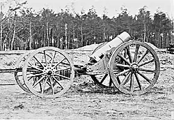 A 21 cm mortar attached to a limber for transport.