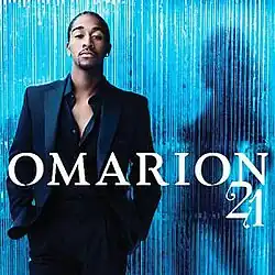 An image of a man wearing a navy blue suit with the top button opened, standing in front of a curtain with the silhouette of a woman beside him. Both the artist's name and album title are colored white.