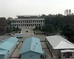 A 1998 photo of a truck in front of Phanmun Pavilion. The truck was part of a 50 truck caravan carrying 501 heads of cattle, which were a gift from Hyundai founder Chung Ju-yung to North Korea.