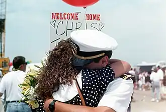 A sailor from the USS Harry W. Hill' returning from a deployment on 8 June 1991