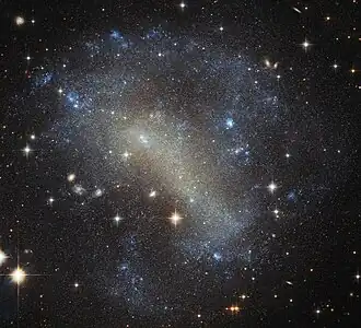 IC 4710 lies roughly 25 million light-years away in the southern constellation of Pavo.[15]