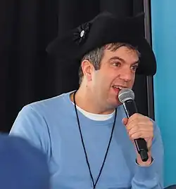 Jacobs reading at 2024 Gaithersburg Book Festival. Jacobs is wearing a tricorn hat.