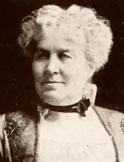 An older white woman with wavy white hair