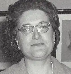 Black and white close portrait of a woman wearing glasses
