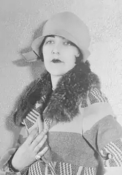 Actress Aileen Pringle wearing a cloche hat and boldly patterned coat, 1926.