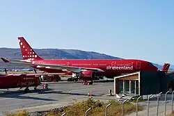 The Air Greenland workmark and starburst trademark in red on a white background
