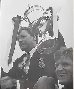 Aberdeen manager Alex Smith is raising the Scottish Cup on the team's victory parade in 1990