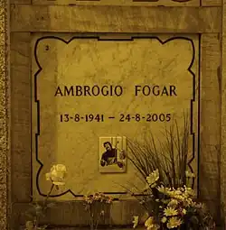 A marble gravestone on the wall of a crypt