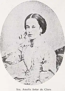 B&W oval portrait of a woman with hair in an up-do, wearing a pale-colored dress.