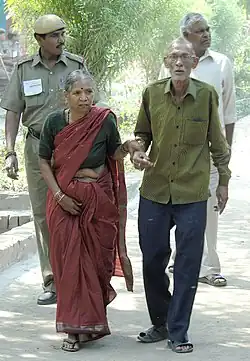 An elderly couple going to cast their vote at a polling booth in East Vinod Nagar