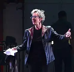 Ann Marie DeAngelo directing on stage at City Center in 2015