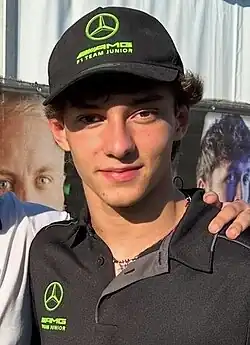Antonelli in a photo with a fan wearing his Mercedes Junior Team apparel at the 2024 Barcelona Formula 2 round