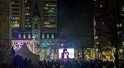 A crowd at night on a public square during a concert