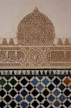 Combination of geometric patterns with arabesque swirls and elegant calligraphy in the Alhambra, Spain