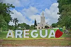 The main church in Areguá and its welcome sign