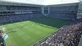Stadium interior with supporters, photographed from one of its corners