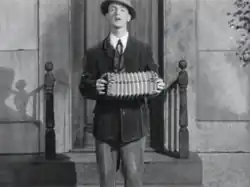 Tracy playing his accordion, from Romantic Melodies (1932)