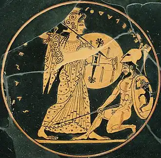 Athena, holding a spear and shield, slays a Giant
