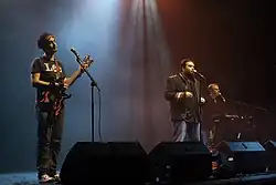 The Axis of Awesome (left to right: Lee Naimo, Jordan Raskopoulos, Benny Davis) performing c. 2011