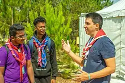 Felipe Paullier on the 16th World Scout Moot in Portugal in discussion with two participant.