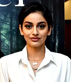 Banita Sandhu wearing a white blouse, looking directly at camera with slight smile