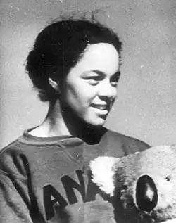 Photo of Barbara Howard looking to the side and holding a stuffed koala bear