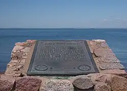 Battle of Sugar Point historical marker with Sugar Point (aka Battle Point) visible in distance across Leech Lake, Whipholt Roadside Park, Whipholt, Minnesota, USA.