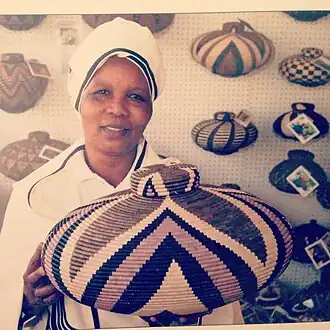 A woman displays her baskets at the Market