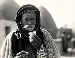 Image 33Syrian Bedouin from a beehive village in Aleppo, Syria, sipping the traditional murra (bitter) coffee, 1930 (from History of coffee)