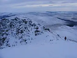 A walker descending by the tourist route, seen from the summit in January 2010.