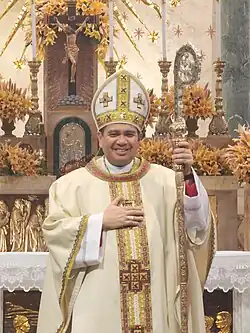 A newly ordained bishop poses for a photo