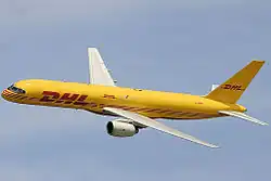 Side view of yellow twin-engine jet in flight