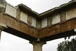Metopes made from marble slotted into the frieze of the Stoa at Brauron