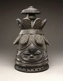 Helmet mask (ndoli jowei) for Sande society; late 19th-early 20th century; wood; 39.4 x 23.5 x 26 cm (151⁄2 x 91⁄4 x 101⁄4 in.); Brooklyn Museum (New York City). A vertical crack runs from base of mask to head band at back center and includes a triangular 13⁄4 hole below band