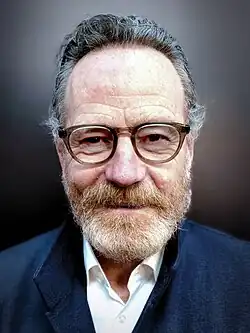 Head shot of Cranston wearing glasses