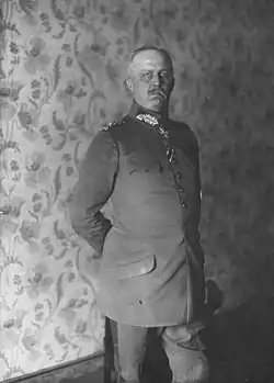 Black and white photo of an elderly man standing in military garb