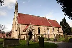 Stone-built church with tile roof and small bellcote