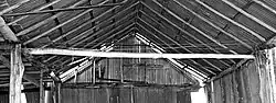Fig. 8: Instead of trusses or joists to brace the walls and support the roof, strands of fencing wire are stretched between the top-plates and tensioned with turnbuckles.