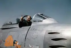Aldrin in a cockpit with canopy pulled back